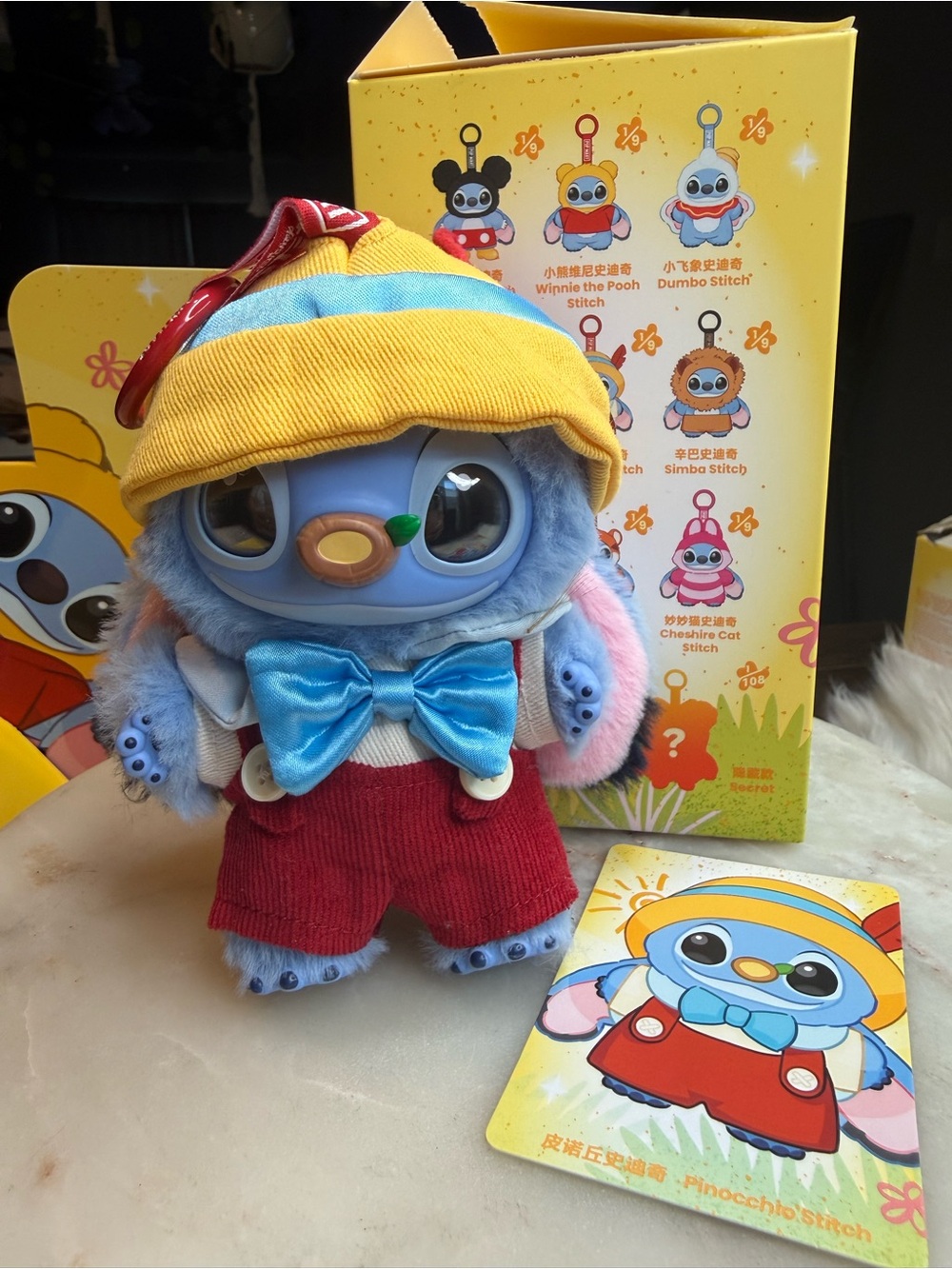 Disney Blue Stitch-Inspired Plush with Yellow Hat, Red Overalls, and Pink Ears